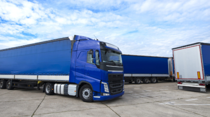 Truck vehicle with trailers in background.