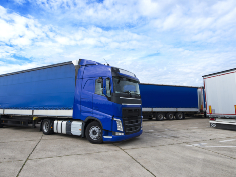 Truck vehicle with trailers in background.