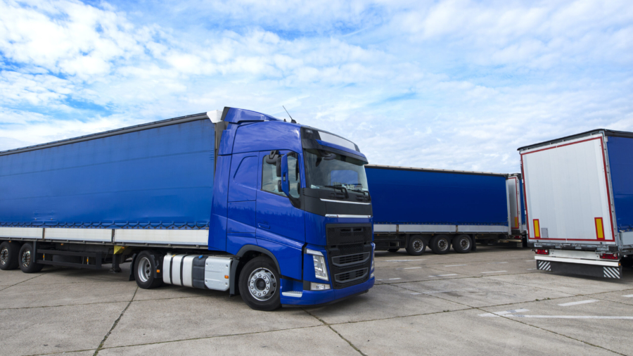 Truck vehicle with trailers in background.